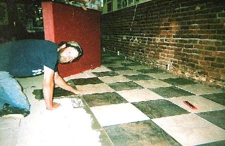 Chris installing large tile checkerboard pattern at Old School Tattoo in downtown Bellingham. 